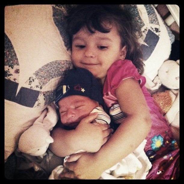 Big sister holding him for the first time <3