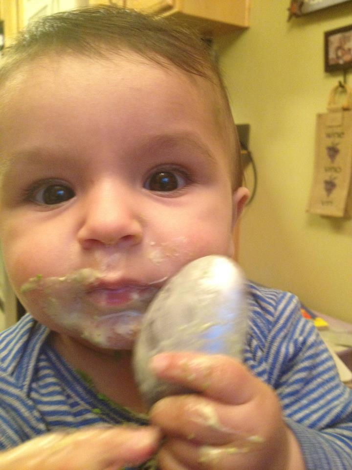 Feeding himself with a spoon at 8 months! 